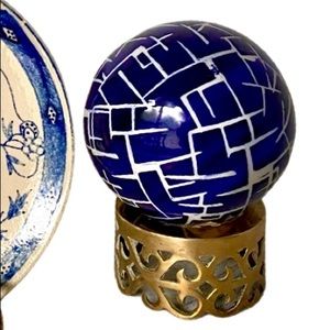 Blue And white carpet ball with brass stand.